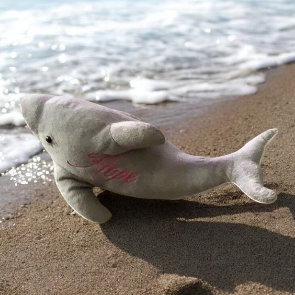 Dolphin stuffed animal says HOPE  with pink stitching . In good shape